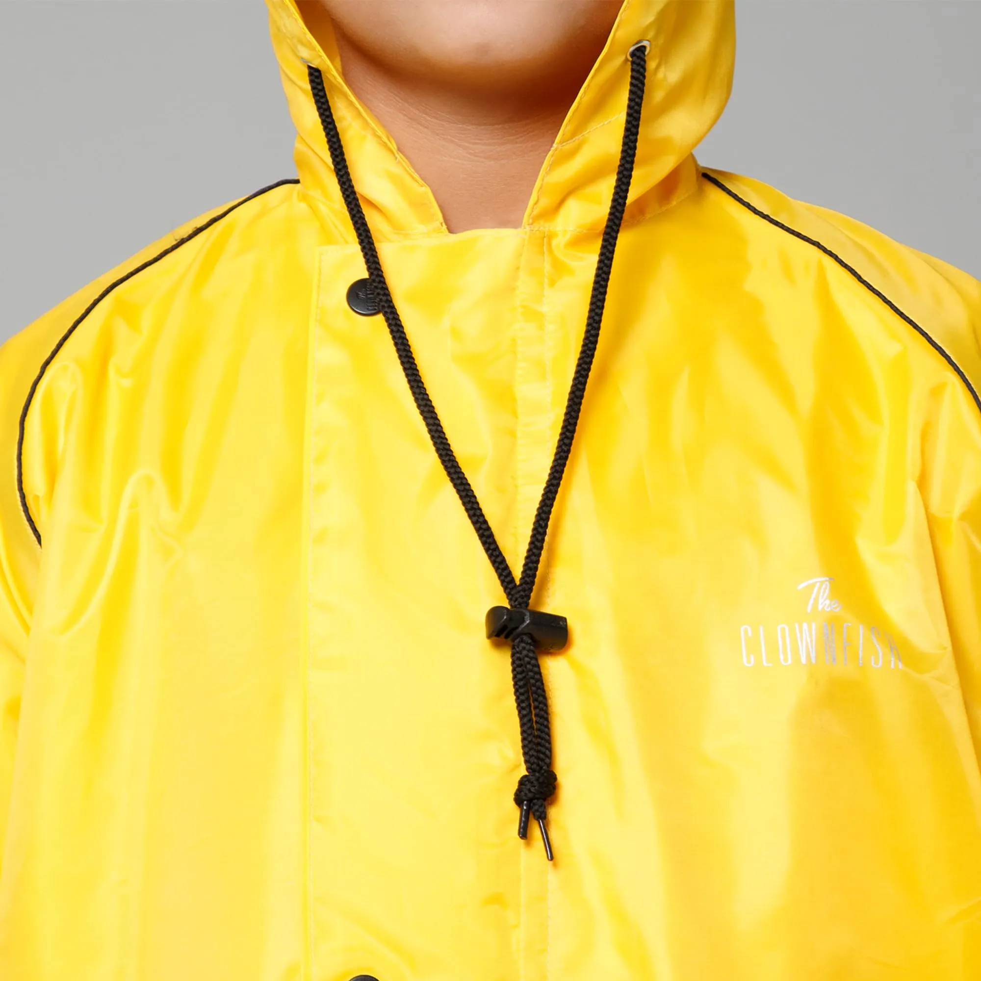 THE CLOWNFISH Duke Series Kids Waterproof Polyester Double Coating Reversible Raincoat with Hood and Reflector Logo at Back. Set of Top and Bottom. Printed Plastic Pouch. Kid Age-5-7 years (Yellow)